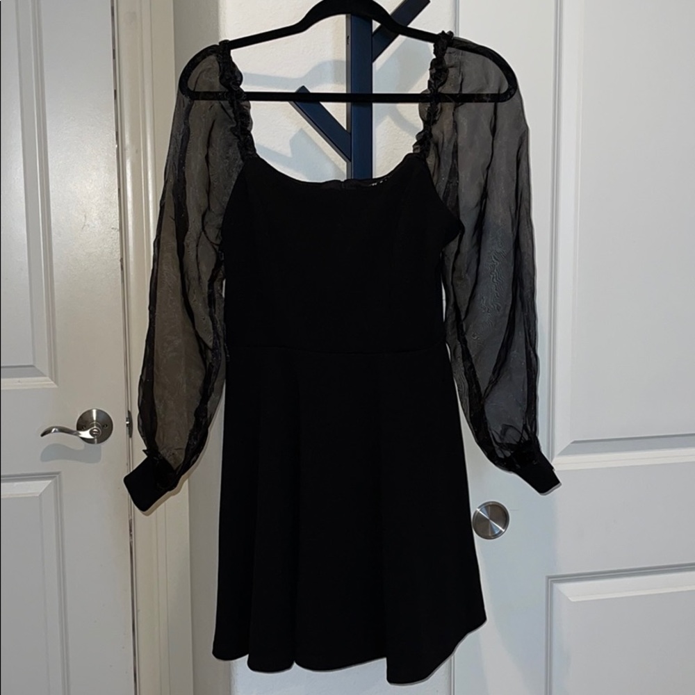 Black dress with sheer sleeves.